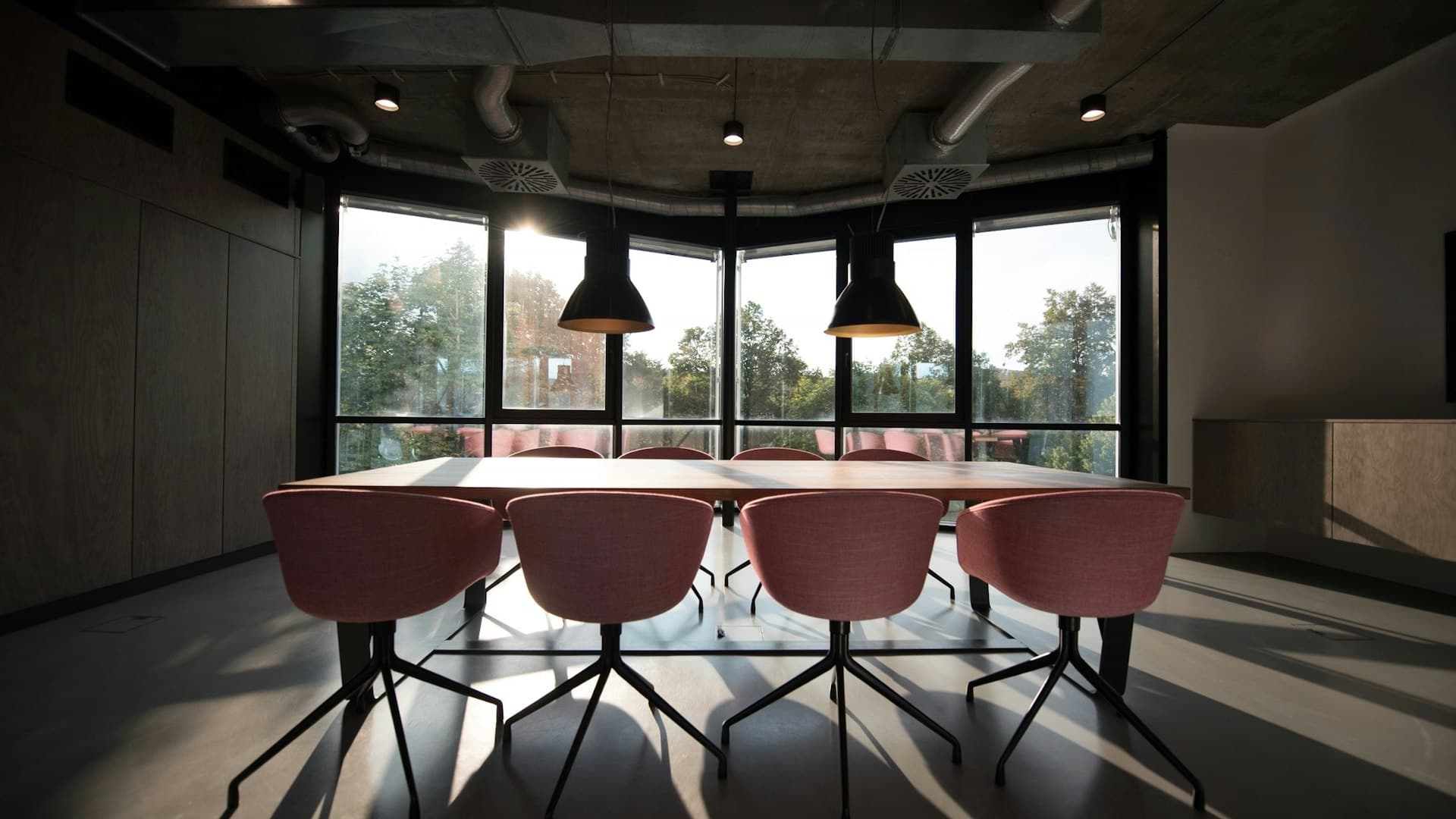 Modern conference room with wood table and upholstered chairs
