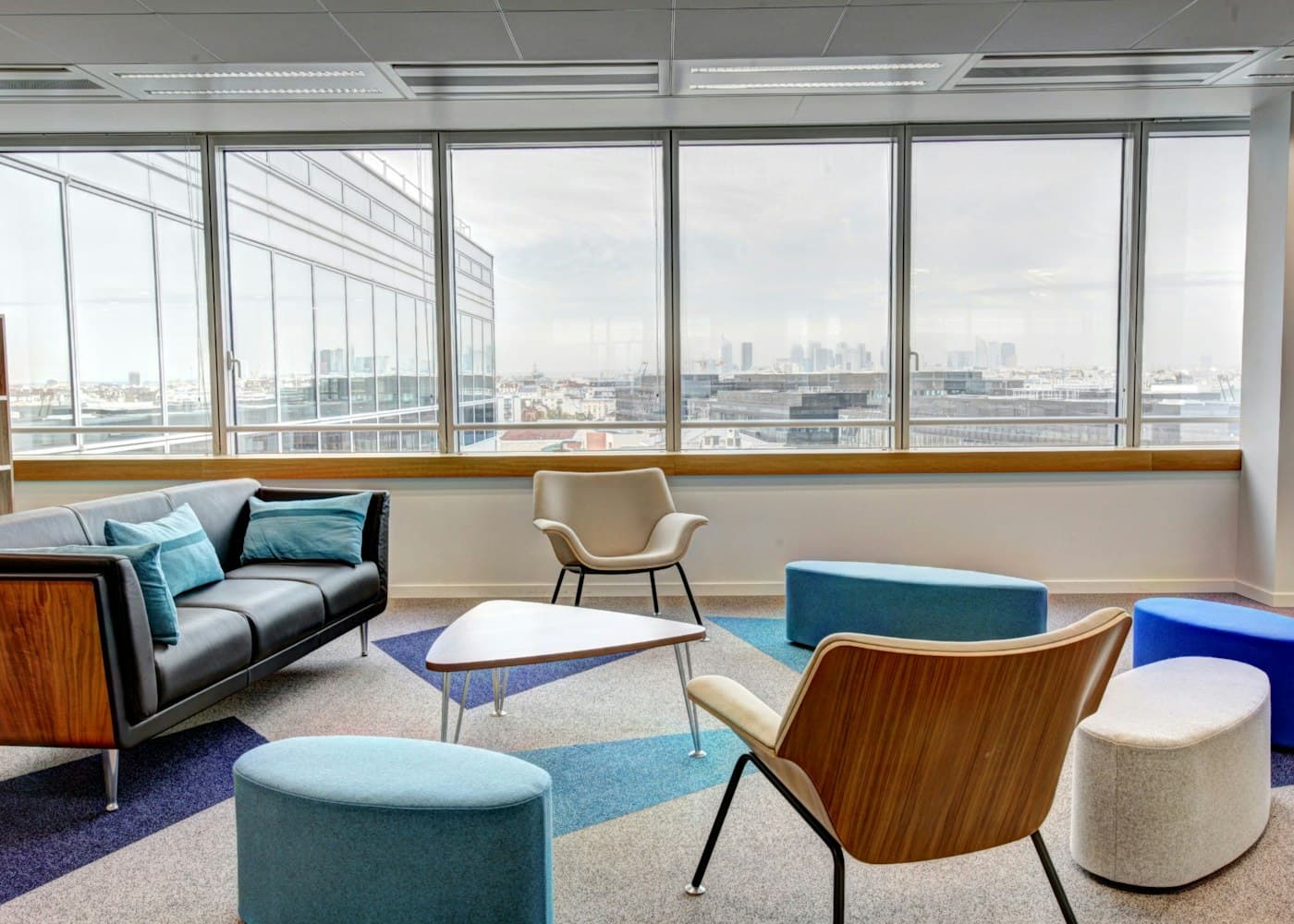 Office lounge and breakout seating with a city skyline view